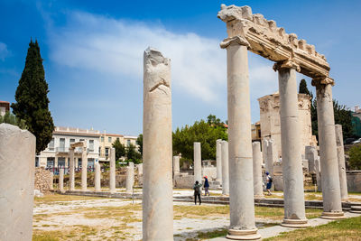 Tourists visiting the ancient ruins at the roman agora  in athens