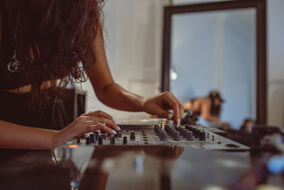 Fashionable young woman playing music at home