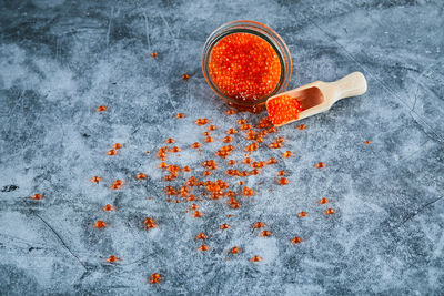 High angle view of orange berries on glass