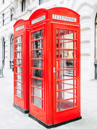 Red telephone booth on street