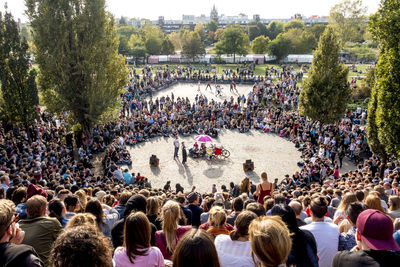 High angle view of people standing by river in city