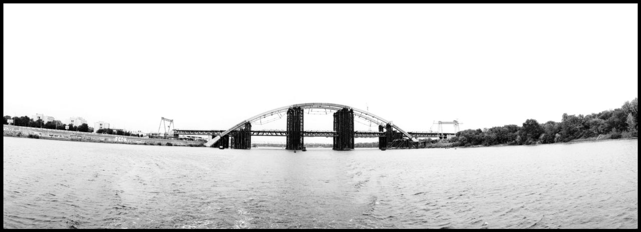 ARCH BRIDGE OVER CALM WATER AGAINST CLEAR SKY