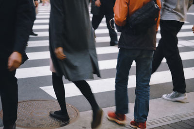 Low section of people walking on street