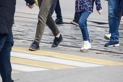 Low section of people walking on road