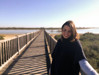 Portrait of young woman at beach during sunset