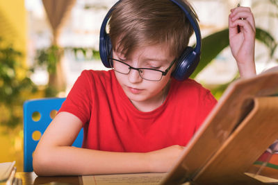 Portrait of cute boy sitting outdoors