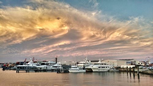 Boats in sea at sunset