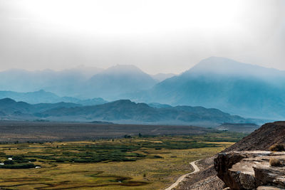 Cliff view of river valley and california forest fire smoke shrouded hills and mountains