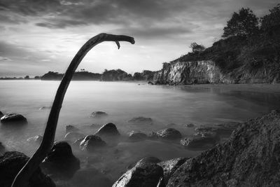 Beach photo landscape with steep cliffs and rocks, long exposure beach photo