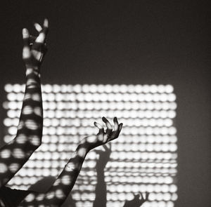 Close-up of woman hand gesturing against wall at home