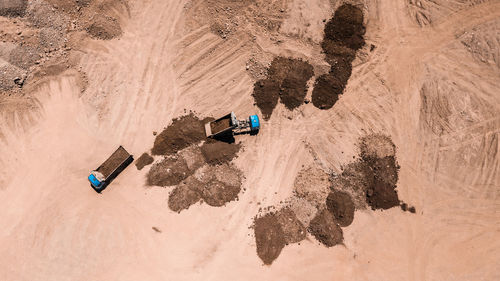 High angle view of trucks on sand