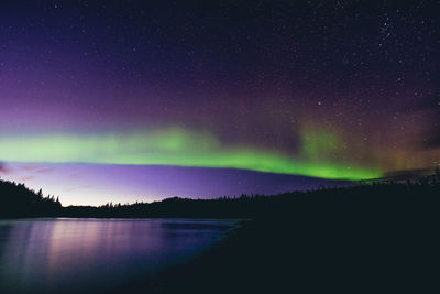 Scenic view of lake against sky at night