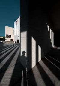 Shadow of person on staircase against building