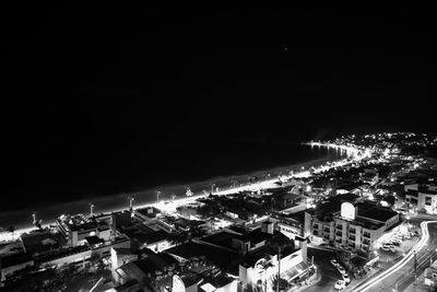 High angle view of illuminated cityscape against sky at night