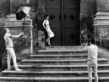 Full length of woman standing on steps