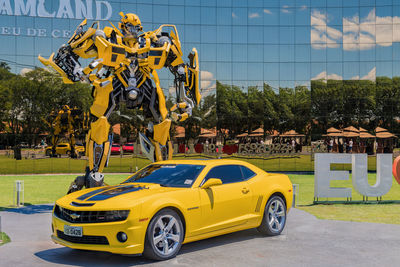 Yellow car on road against sky