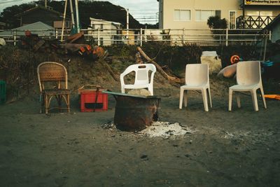 Empty chairs and table in abandoned building