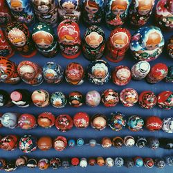 Full frame shot of dolls on rack at market