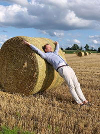 Rear view of woman standing on hay