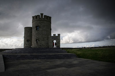 Castle tower against sky at dusk