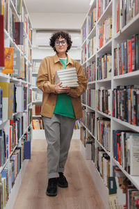 Portrait of woman standing in library