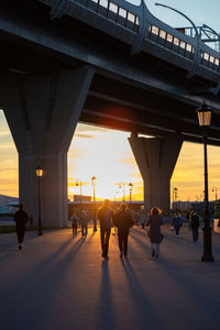 Silhouette people walking on road