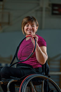 Portrait of young woman sitting on chair