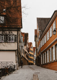 Road amidst residential buildings against sky