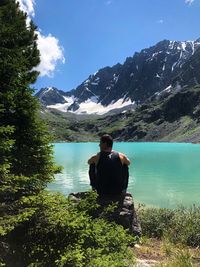 Man looking at lake against mountain range