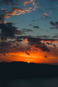 Scenic view of dramatic sky over sea during sunset