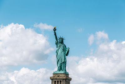 Low angle view of statue against cloudy sky