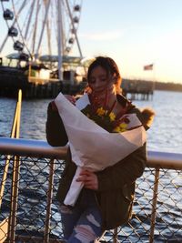 Young woman standing at harbor