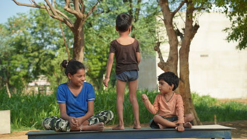Funny kids doing yoga pose in the park outdoor. healthy life style concept.