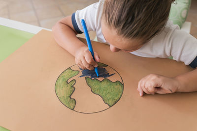 Girl coloring earth planet sketch at home