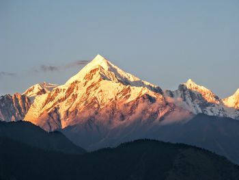 Scenic view of snowcapped mountains against sky at night