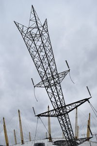 Low angle view of cranes against sky