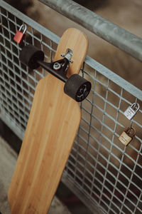 High angle view of skateboard on fence