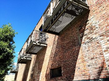 Low angle view of building against clear blue sky