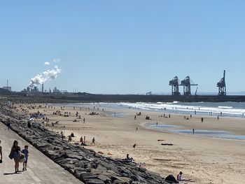 People on beach against sky