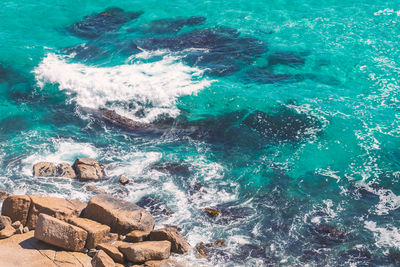 High angle view of rocks in sea