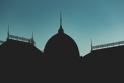 Low angle view of silhouette cathedral against sky