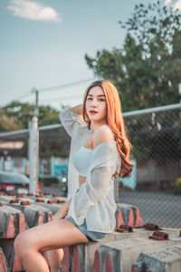 Beautiful young woman standing in park