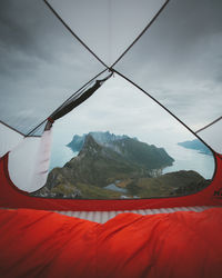 Scenic view out of a tent  of snowcapped mountains against sky