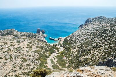 High angle view of sea and mountains against sky