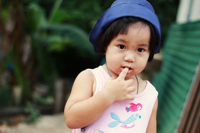 Portrait of cute baby girl holding outdoors