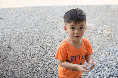 Portrait of cute boy standing on stones