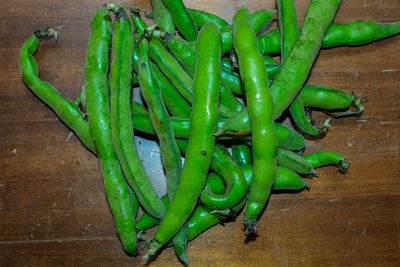 High angle view of green chili peppers on table