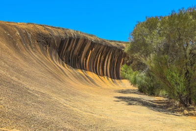 Scenic view of land against clear blue sky