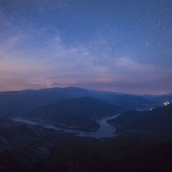 Scenic view of mountains against sky at night