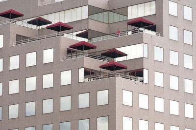 Low angle view of red umbrellas on building